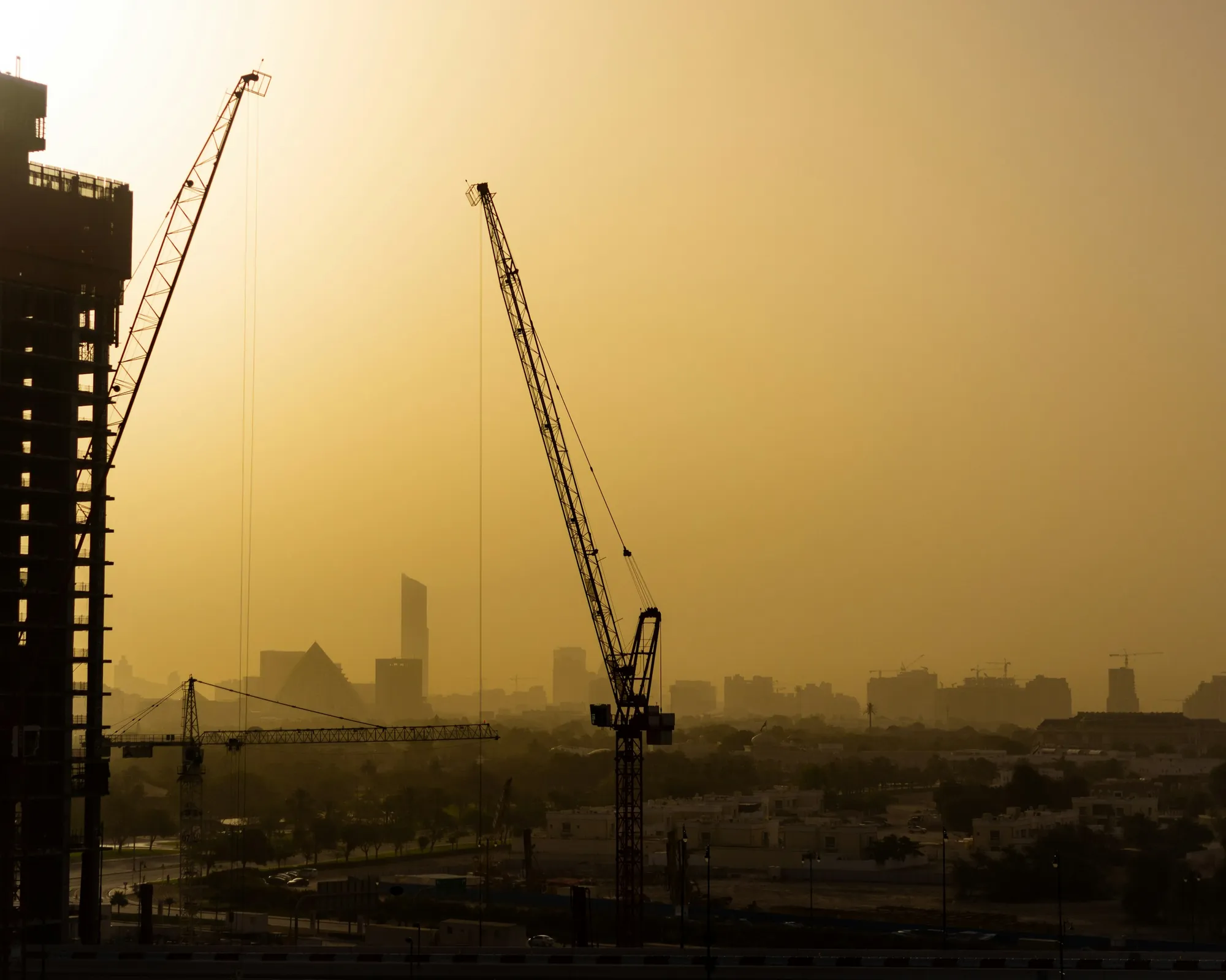 A tower crane against a sunset